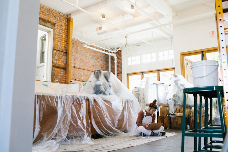 Scout Coffee cafe with the bar and furniture covered in plastic sheeting during the early days of COVID