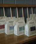 HoneyCo bags lined up across the bench