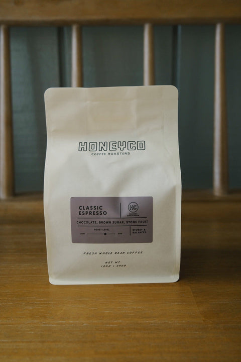 A bag of HoneyCo Classic Espresso on a wooden table