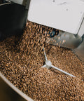 Freshly roasted coffee dropping into the cooling tray