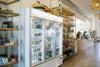 Bags of HoneyCo coffee and goods on the shelves in Morro Bay