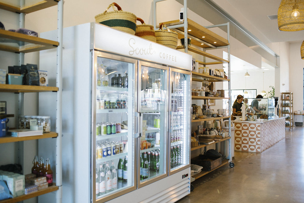 Bags of HoneyCo coffee and goods on the shelves in Morro Bay