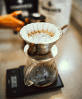 Coffee brewing in a pour-over cone on a scale