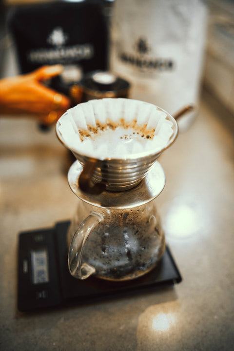 Coffee brewing in a pour-over cone on a scale